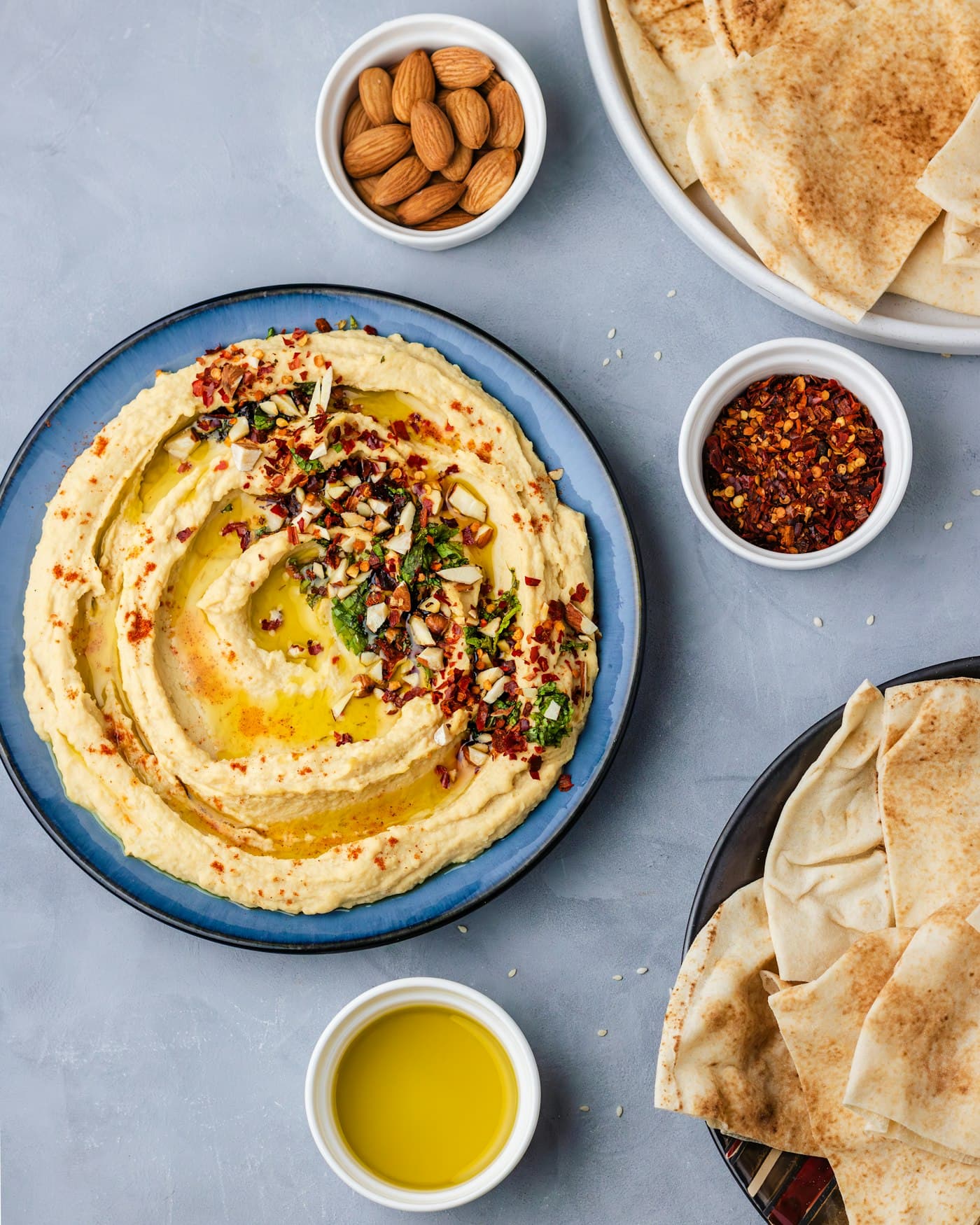Houmous à l'huile d'olive et pains pita sur une table