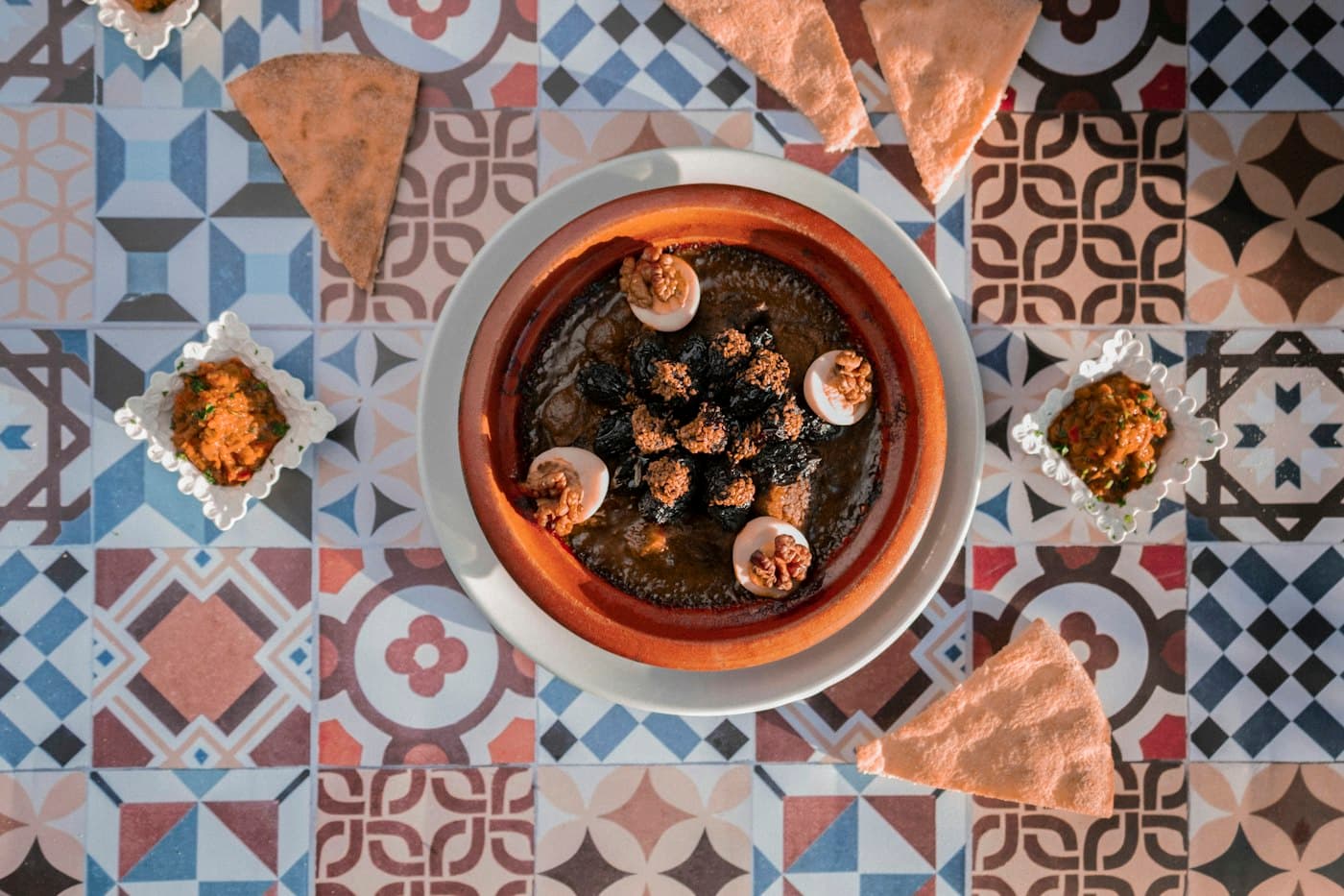 Tajine de viande et œufs dans son plat en terre, vu de dessus